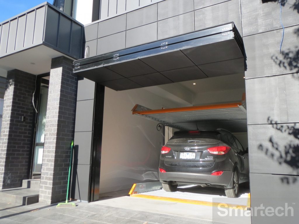 Flush Finish Folding Facade Garage Door open showing Hyundai SUV