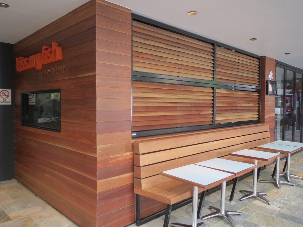 Closed folding louvres above outdoor seating