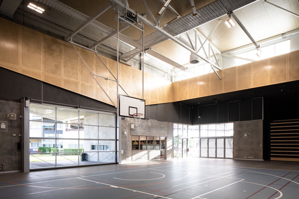 school gym and basketball court with a single very large folding door closed.