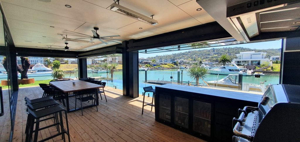 Overlooking a beautiful bay, full of boats through two open Folding Walls