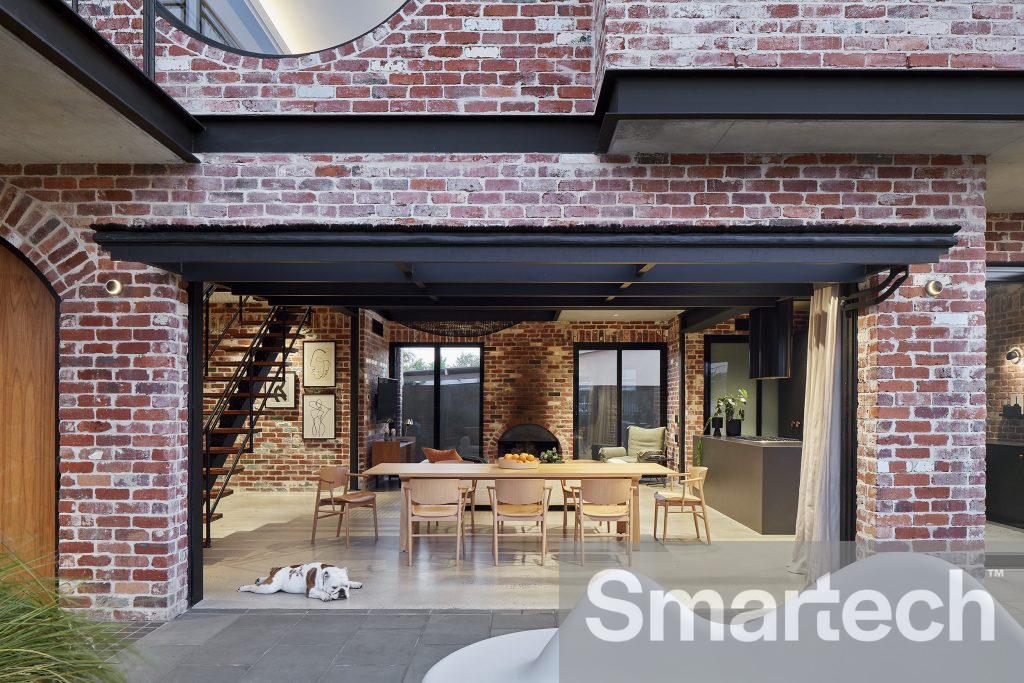 Red Brick House with an open glazed tilt door providing access to the kitchen and dinning room.