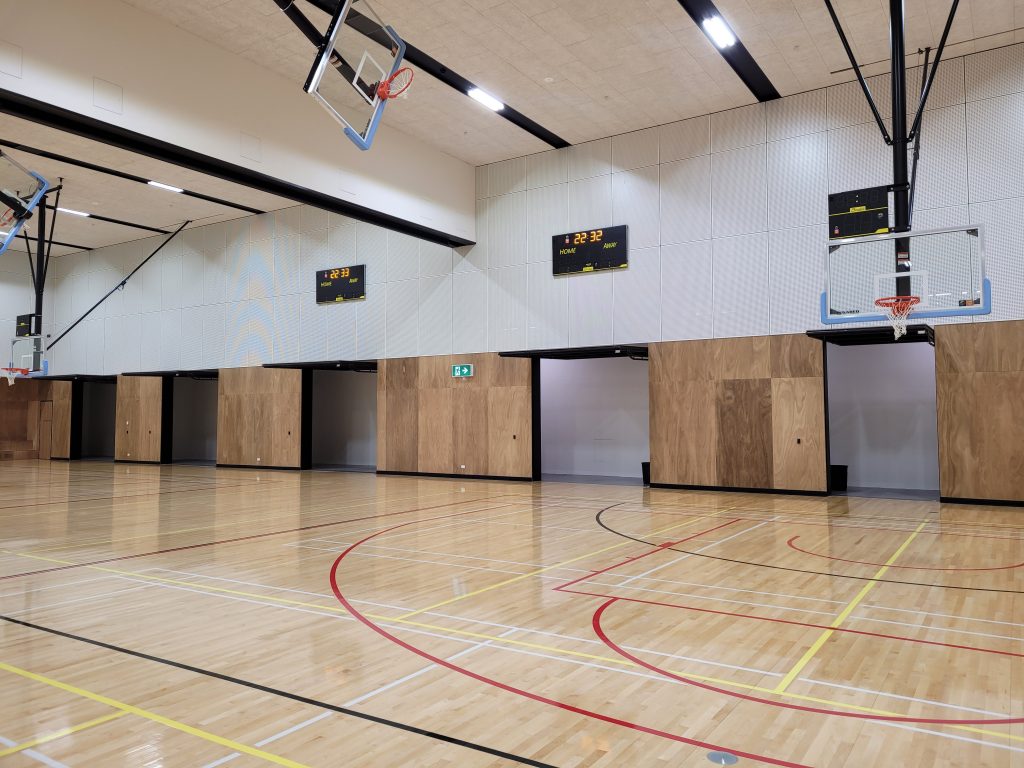 another angle of a school gym with open tilt doors