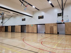 another angle of a school gym with open tilt doors