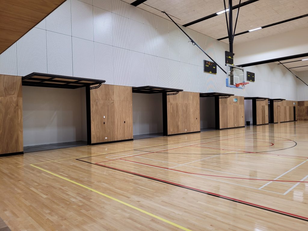 multiple tilt doors opened for the days activites in a school gym