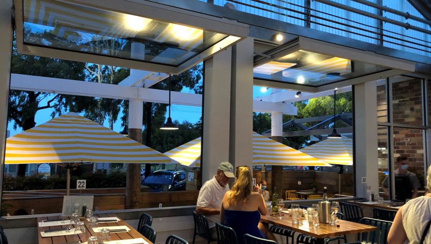white tilt windows opened while diners enjoy dinner