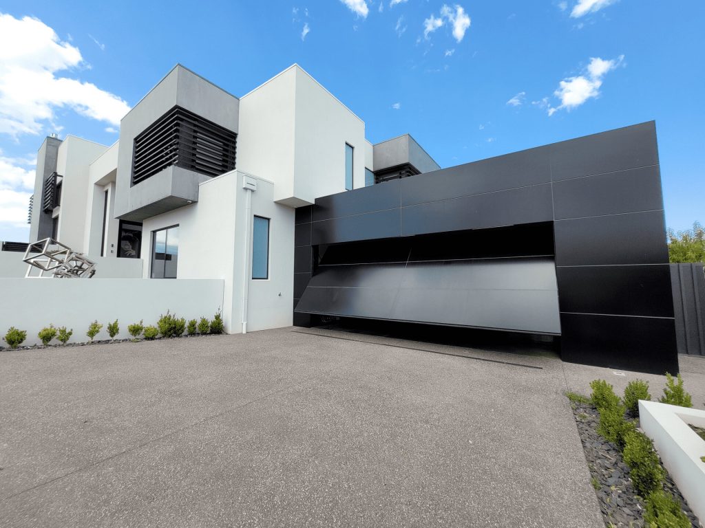 Enhance the look of your home's exterior with a Façade Garage Door featuring Alucobond composite paneling. This image highlights its sleek design and strength.