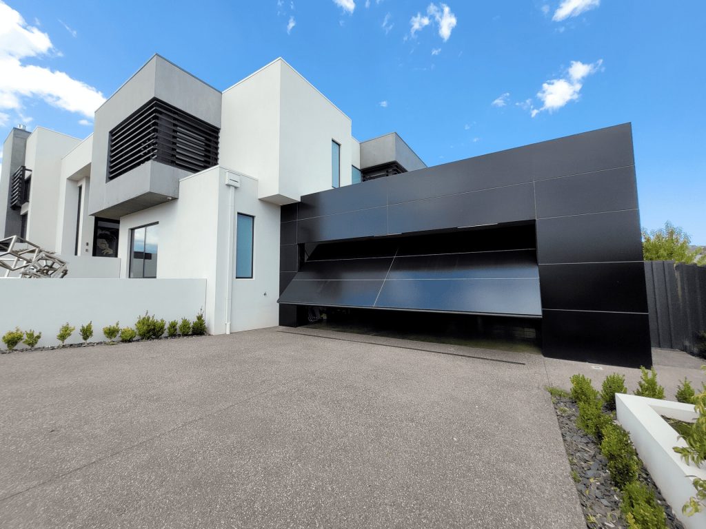 See the modern Façade Garage Door with Alucobond composite paneling. This image showcases its durability and stunning curb appeal.